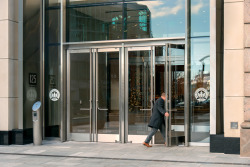 business man walking through double-leaf doors